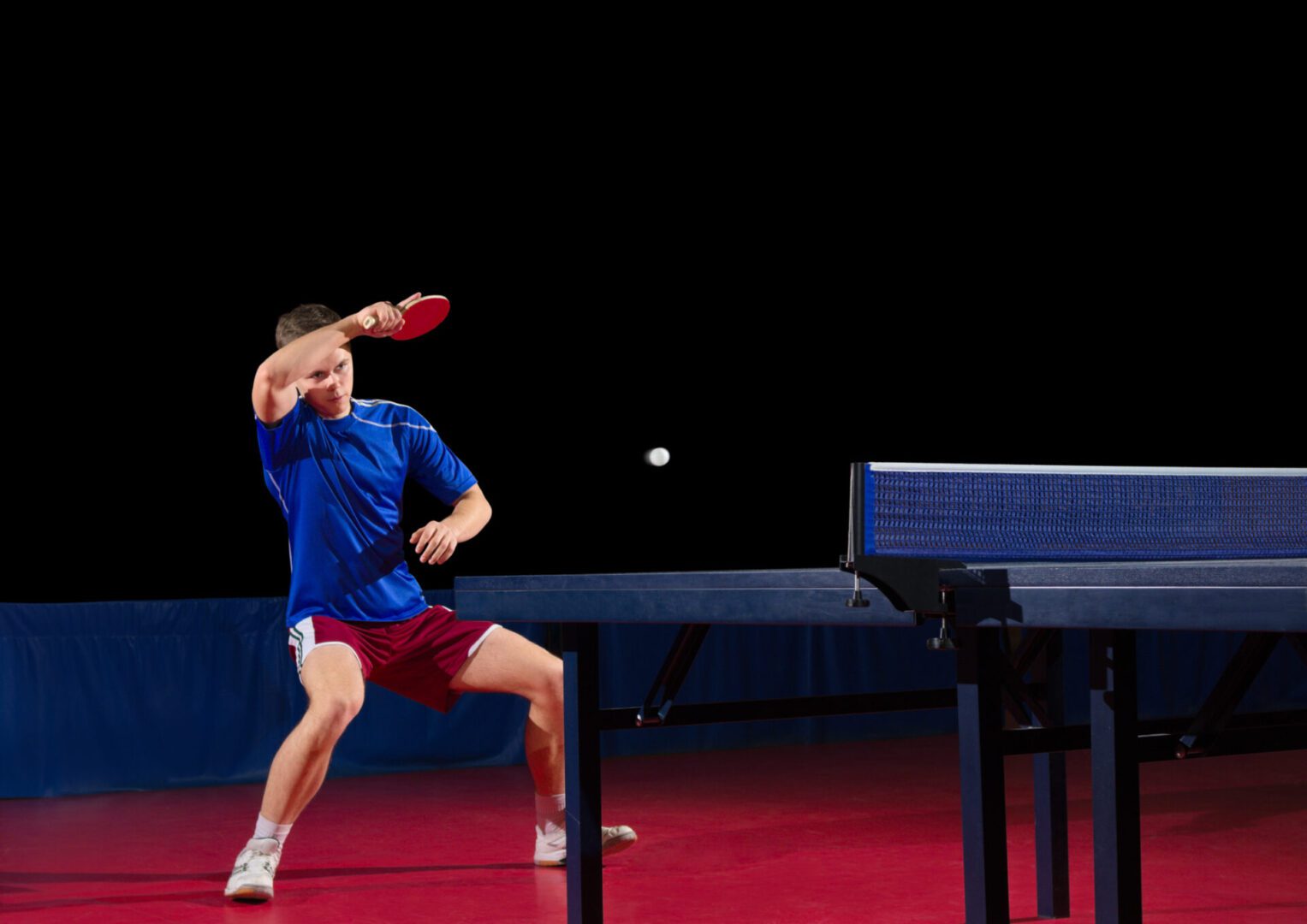 Table tennis player isolated on black