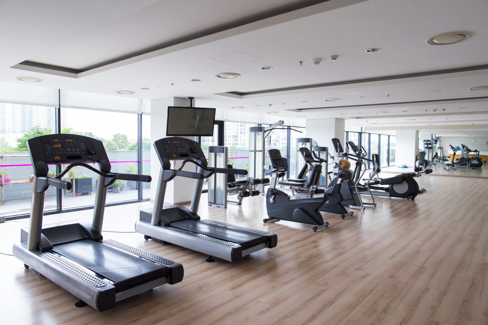Hotel fitness gym interior with row of sports equipment